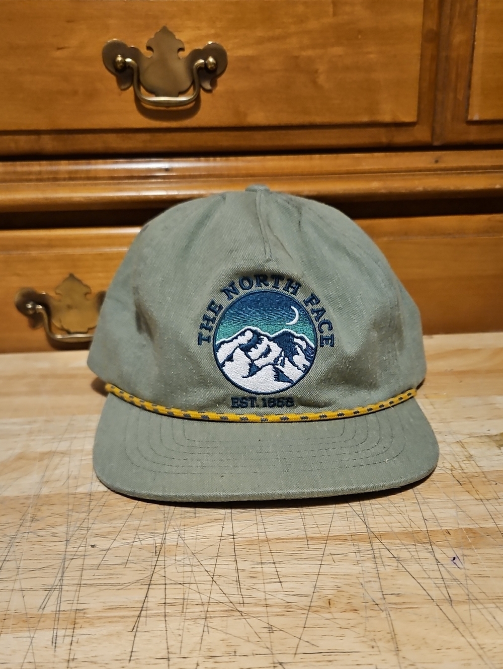 The North Face Olive Green Hat with Yellow Trim and Mountain Patch